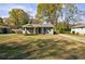 Charming exterior showcasing a cozy home with a well-manicured lawn and covered front porch at 1019 Magbee Se Dr, Smyrna, GA 30080