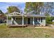Charming home with a covered porch, green siding, and a well-maintained lawn at 1019 Magbee Se Dr, Smyrna, GA 30080