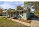Charming light green home with a welcoming front porch and well-manicured lawn, perfect for curb appeal at 1019 Magbee Se Dr, Smyrna, GA 30080