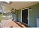 Charming front porch with wood deck and black front door, enhancing the home's curb appeal at 1019 Magbee Se Dr, Smyrna, GA 30080