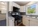 Well-equipped kitchen features modern appliances, granite countertops, and ample cabinet space, perfect for cooking at 1019 Magbee Se Dr, Smyrna, GA 30080