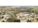 Aerial view showcasing a neighborhood and pond surrounded by lush greenery and mature trees at 1340 Summer Lake Ter, Loganville, GA 30052