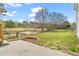 Lush backyard with green grass, mature trees, and a small pond with fence at 1340 Summer Lake Ter, Loganville, GA 30052