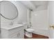 Well-lit bathroom featuring a modern vanity, toilet, and a shower with a white tub at 1340 Summer Lake Ter, Loganville, GA 30052
