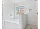 Modern bathroom featuring a soaking tub, walk-in shower, and tile throughout for a luxurious spa experience at 1340 Summer Lake Ter, Loganville, GA 30052