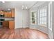 Bright dining area featuring wood floors, large windows, chandelier, and access to the kitchen at 1340 Summer Lake Ter, Loganville, GA 30052
