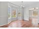 Bright dining area featuring wood floors, large windows, and modern lighting fixture at 1340 Summer Lake Ter, Loganville, GA 30052