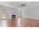 Spacious living room with tray ceilings, hardwood flooring, marble fireplace, and access to an outdoor deck at 1340 Summer Lake Ter, Loganville, GA 30052