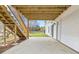 Outdoor patio area under the deck with stairs and a door leading into the house at 1340 Summer Lake Ter, Loganville, GA 30052