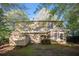 A backyard with a small shed and a two-story house visible, surrounded by trees at 1946 Glenwood Downs Dr, Decatur, GA 30035
