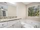 The bathroom features a granite vanity countertop and a tub under a window at 1946 Glenwood Downs Dr, Decatur, GA 30035