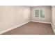This cozy bedroom features neutral walls and carpet and a window with blinds at 1946 Glenwood Downs Dr, Decatur, GA 30035