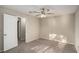 This bedroom features neutral walls and carpet, a window with blinds, and a ceiling fan at 1946 Glenwood Downs Dr, Decatur, GA 30035