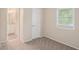 This cozy bedroom features neutral walls and carpet and a window with blinds at 1946 Glenwood Downs Dr, Decatur, GA 30035