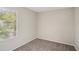 This cozy bedroom features neutral walls and carpet and a window with blinds at 1946 Glenwood Downs Dr, Decatur, GA 30035