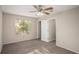 This bedroom features neutral walls and carpet, a window with blinds, and a ceiling fan at 1946 Glenwood Downs Dr, Decatur, GA 30035