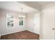 Cozy dining room with hardwood floors, a chandelier, and natural light from two windows at 1946 Glenwood Downs Dr, Decatur, GA 30035