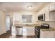 Modern kitchen with granite countertops, stainless steel appliances and white cabinetry at 1946 Glenwood Downs Dr, Decatur, GA 30035