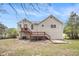 Backyard view featuring a deck, patio, and well-maintained landscaping perfect for outdoor entertaining at 3380 Saddleton Way, Douglasville, GA 30134