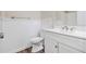 Well-lit bathroom features a modern vanity, toilet, shower and contrasting white paneling at 3380 Saddleton Way, Douglasville, GA 30134