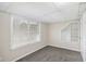 Cozy bedroom featuring a built-in wall shelf, a window with blinds, and neutral gray carpeting at 3380 Saddleton Way, Douglasville, GA 30134