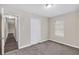 Comfortable bedroom showcasing soft carpet, neutral walls, and a closet for ample storage with hall access at 3380 Saddleton Way, Douglasville, GA 30134