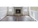 Cozy living room showcasing a stone fireplace, hardwood floors, and natural light creating a warm ambiance at 3380 Saddleton Way, Douglasville, GA 30134