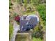 Aerial view of a house with a pool surrounded by lush greenery, a long driveway and mature trees at 3510 Donegal Way, Snellville, GA 30039