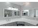 Bright primary bathroom with stylish fixtures, double mirrors, and a glass-enclosed shower at 3510 Donegal Way, Snellville, GA 30039