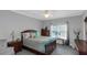 This primary bedroom features a ceiling fan, carpet, and window for natural light at 3510 Donegal Way, Snellville, GA 30039