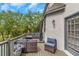 Cozy deck with outdoor seating, a table, and a gray wooden surface under a partly cloudy sky at 3510 Donegal Way, Snellville, GA 30039