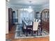 Formal dining room with beautiful chandelier, wooden floor and matching wooden furniture at 3510 Donegal Way, Snellville, GA 30039