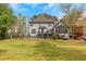 Rear exterior view of a charming home with a well-maintained lawn and beautiful windows at 3510 Donegal Way, Snellville, GA 30039
