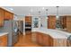 Bright eat-in kitchen with stainless steel appliances, wood cabinets, and spacious countertops at 3510 Donegal Way, Snellville, GA 30039