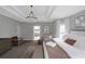 Light-filled main bedroom with tray ceiling, chandelier, sitting area, and ensuite bath at 3510 Donegal Way, Snellville, GA 30039