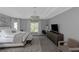 A spacious bedroom offers great natural light and features a chandelier and sitting area at 3510 Donegal Way, Snellville, GA 30039