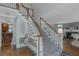 Grand foyer with a carpeted staircase, white railings, and wood accents leading to the upper level at 3510 Donegal Way, Snellville, GA 30039