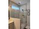 Modern bathroom featuring tiled walls, a glass-enclosed shower and vanity with sink at 63 Aspen Way, Dallas, GA 30157