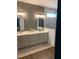 Bathroom featuring dual sinks, stylish mirrors, and a glass-enclosed shower at 63 Aspen Way, Dallas, GA 30157