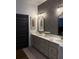 Double vanity bathroom featuring floral wallpaper, gold hardware and modern fixtures at 63 Aspen Way, Dallas, GA 30157
