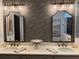 Double vanity bathroom featuring floral wallpaper, gold hardware and modern fixtures at 63 Aspen Way, Dallas, GA 30157
