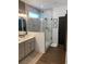 Modern bathroom featuring a glass shower, gray cabinets and luxury finishes at 63 Aspen Way, Dallas, GA 30157