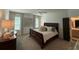 A primary bedroom features a dark wood bed frame, white walls and ceiling fan at 63 Aspen Way, Dallas, GA 30157