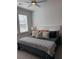 Bright bedroom with a ceiling fan and a comfortable bed with stylish bedding at 63 Aspen Way, Dallas, GA 30157