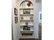 Built-in shelves beautifully decorated with neutral decorative objects and picture frames at 63 Aspen Way, Dallas, GA 30157