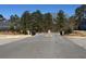 Entryway to a neighborhood featuring mature trees and well-maintained roads at 63 Aspen Way, Dallas, GA 30157