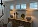 Dining room buffet with decorative lamps and decor, and shuttered windows at 63 Aspen Way, Dallas, GA 30157