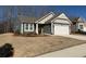 Charming single-story home featuring a welcoming facade and well-maintained landscaping at 63 Aspen Way, Dallas, GA 30157