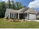 Charming single-story home features manicured lawn and a two-car garage at 63 Aspen Way, Dallas, GA 30157