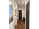 Well-lit hallway with wood flooring and stylish gray doors, creating a welcoming and visually appealing transition between spaces at 63 Aspen Way, Dallas, GA 30157